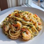 A close-up serving of delicious garlic butter shrimp pasta, featuring plump shrimp tossed with linguine and fresh parsley.